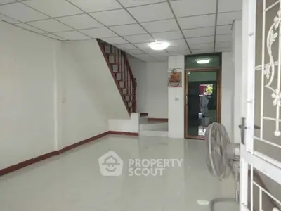 Spacious interior with staircase and tiled flooring, ideal for customization.