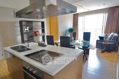 Modern open-layout kitchen and dining area with sleek design and natural light.