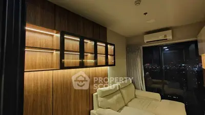 Modern living room with city view, featuring stylish wooden paneling and cozy beige sofa.