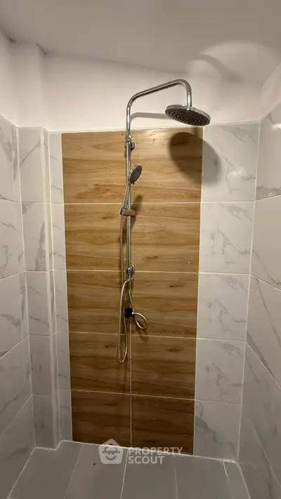 Modern bathroom shower with elegant tile design and rainfall showerhead