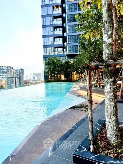 Luxurious high-rise building with stunning infinity pool and city view, perfect for urban living.