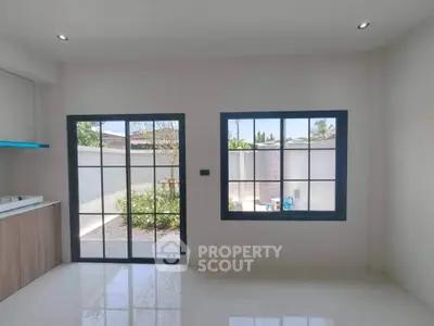 Bright modern interior with large windows and garden view, perfect for natural light lovers.