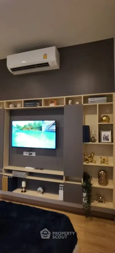 Modern living room with stylish entertainment center and air conditioning