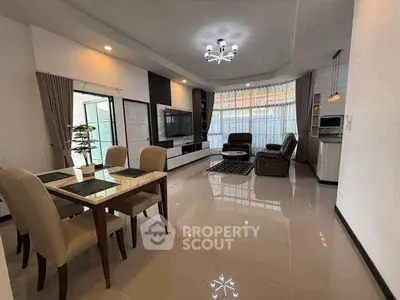 Spacious modern living room with elegant dining area and large windows.