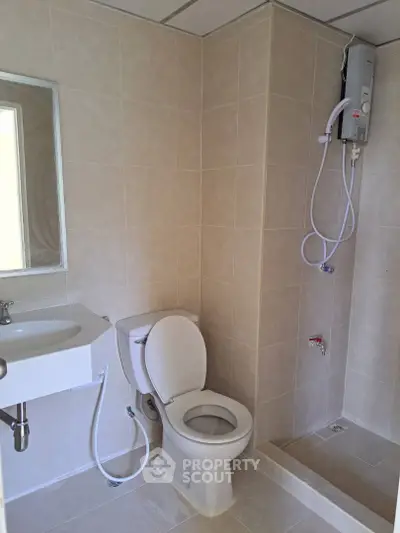 Modern bathroom with shower and toilet in a tiled setting