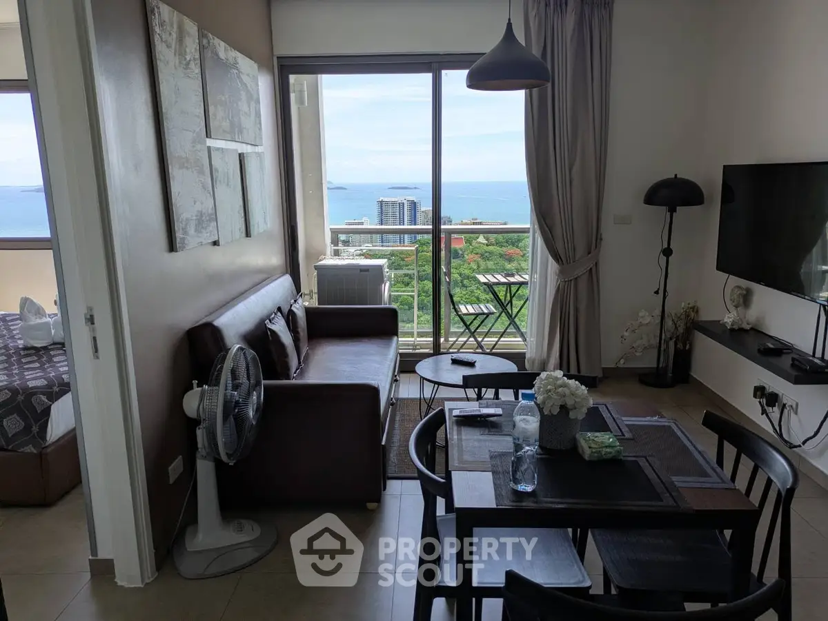 Modern living room with ocean view, stylish decor, and open layout in a high-rise apartment.