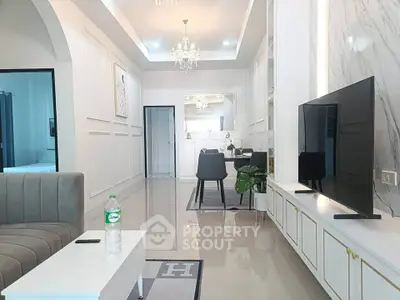 Luxurious modern living room with elegant decor and large flat-screen TV