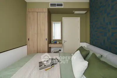 Stylish bedroom with modern decor and cozy bedding in a contemporary apartment.