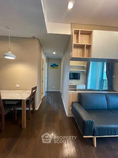 Modern living room with sleek furniture and hardwood floors in a stylish apartment.