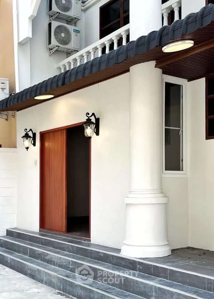Elegant entrance with classic columns and modern lighting