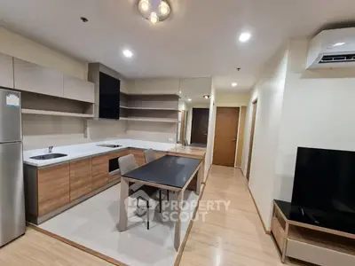 Modern kitchen and dining area with sleek design and integrated appliances