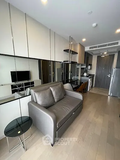 Modern apartment interior with sleek design and compact layout, featuring a cozy living area and stylish kitchen.