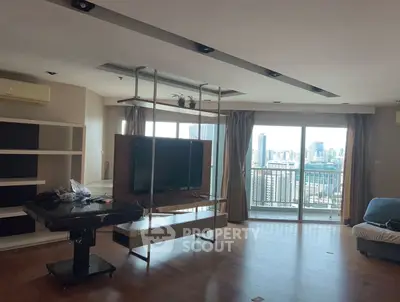 Spacious living room with city view and modern TV setup