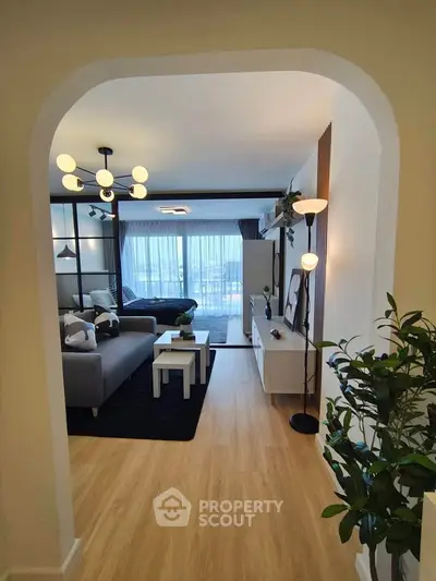 Modern living room with stylish decor and large windows offering natural light.