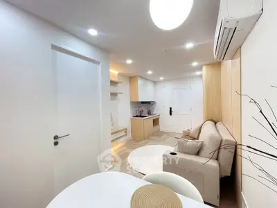 Modern living room with cozy sofa and stylish kitchen in open layout