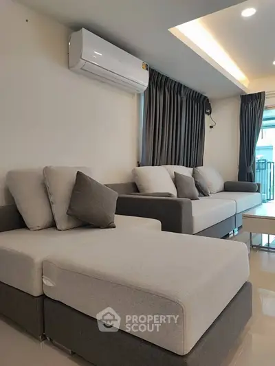 Modern living room with stylish sofas and air conditioning