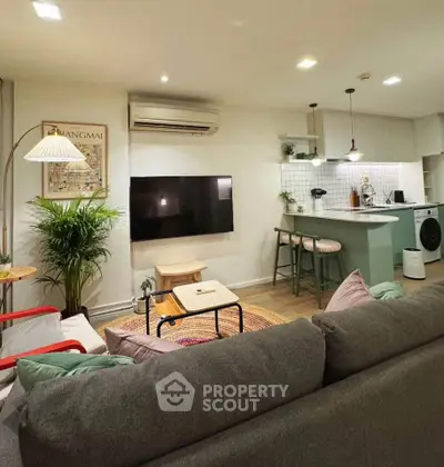 Stylish living room with modern decor and open kitchen layout
