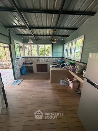 Charming open-layout kitchen with modern appliances and scenic outdoor views, perfect for culinary enthusiasts.