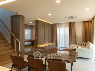 Spacious modern living room with elegant dining area and cozy seating, perfect for family gatherings.