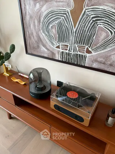 Stylish living room with modern decor and vintage record player on wooden console.