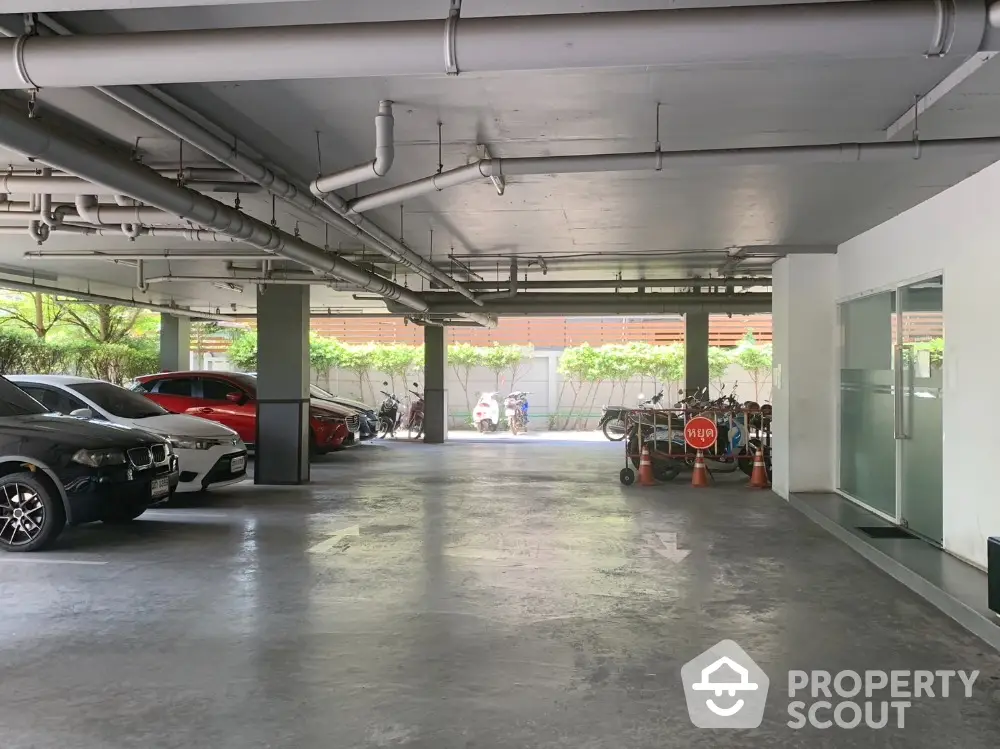 Spacious indoor parking area with multiple cars and natural light