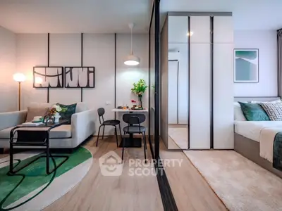 Modern living room with stylish decor and cozy bedroom in open layout apartment.