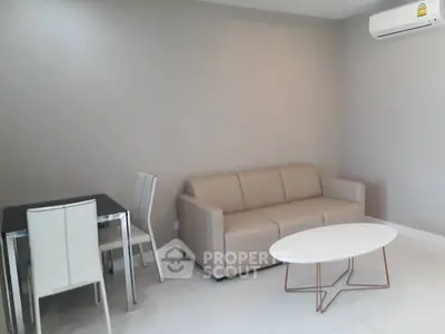 Modern living room with beige sofa and sleek dining set