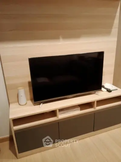 Modern living room with sleek TV unit and wooden flooring