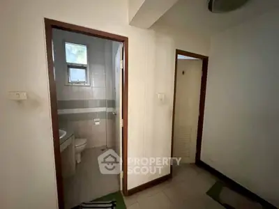 Cozy interior with bathroom and hallway, ideal for compact living spaces.