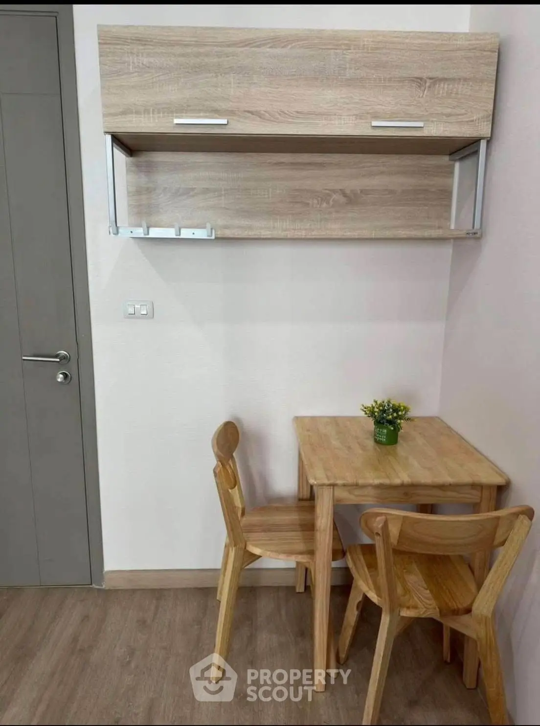 Cozy dining nook with wooden table and chairs, perfect for small spaces.