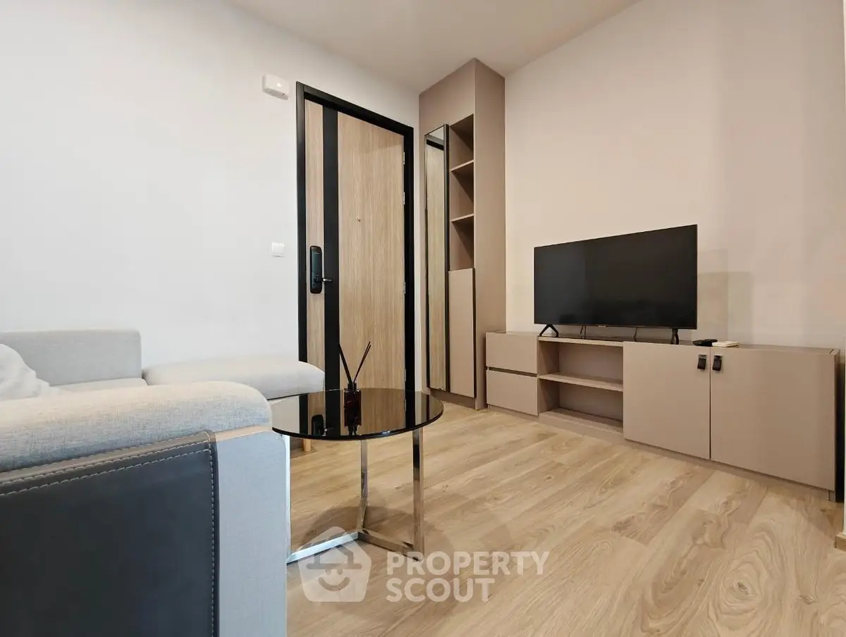 Modern living room with sleek furniture and wooden flooring