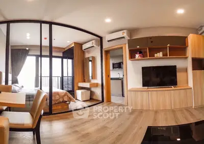Modern open-plan living room with glass partition and stylish decor
