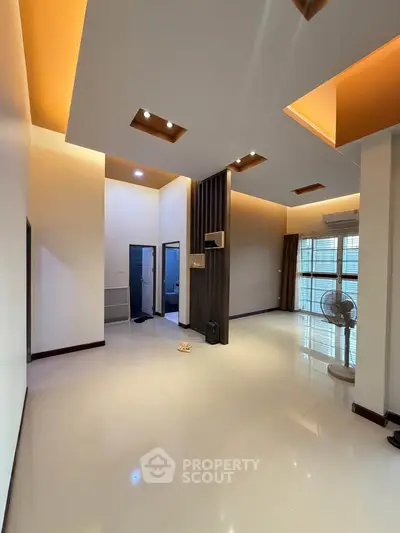 Spacious modern living room with high ceilings and elegant lighting