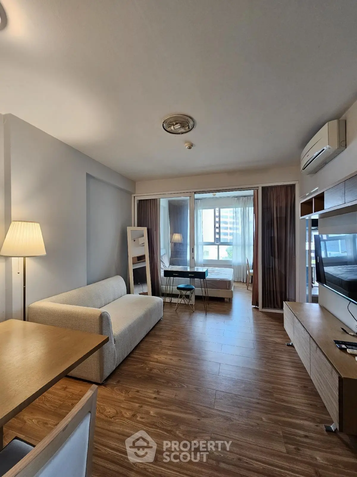 Modern studio apartment with cozy living area and natural light