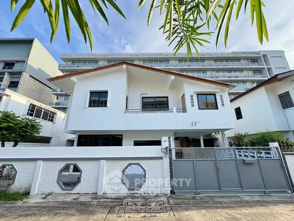 Charming white house with modern design and spacious exterior in urban setting.