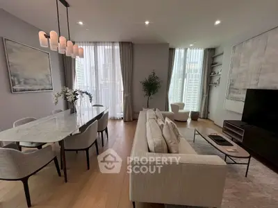 Elegant modern living room with dining area, featuring floor-to-ceiling windows and stylish decor.