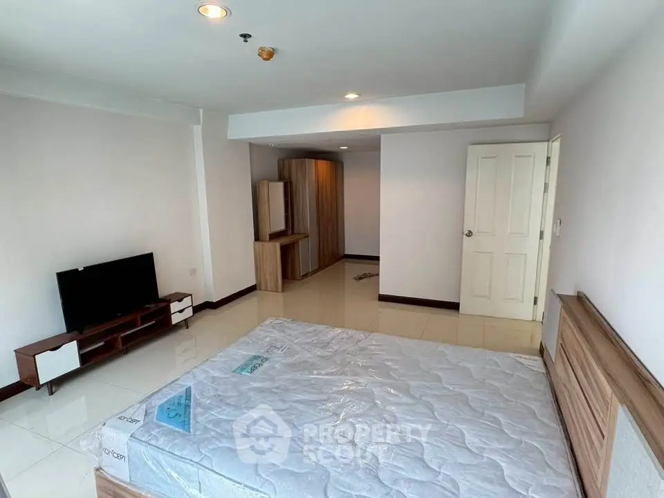 Spacious bedroom with modern furniture and natural light