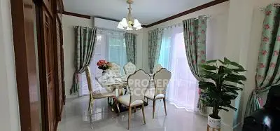 Elegant dining room with floral curtains and stylish chandelier