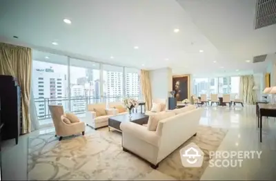 Expansive living room with plush seating and floor-to-ceiling windows offering a panoramic city view, perfect for upscale urban living.