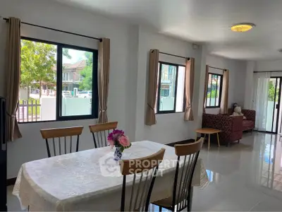 Spacious dining area with natural light and garden view, perfect for family gatherings.