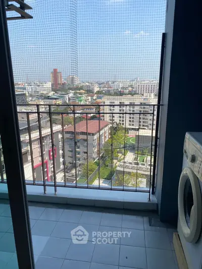 High-rise apartment balcony with stunning city view and washing machine