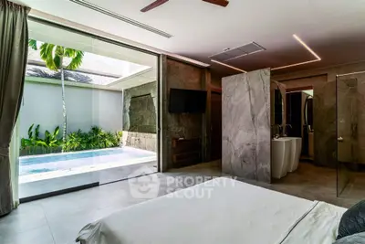Luxurious bedroom with pool view and modern design in tropical villa