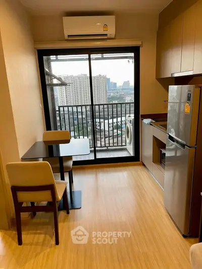Modern apartment kitchen with dining area and balcony view