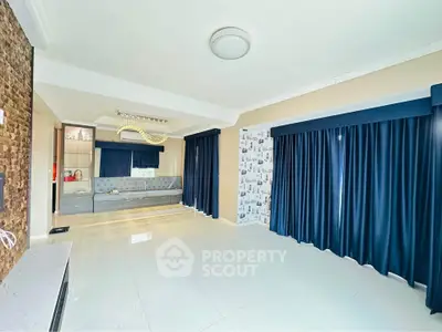 Spacious modern living room with elegant blue curtains and stylish lighting