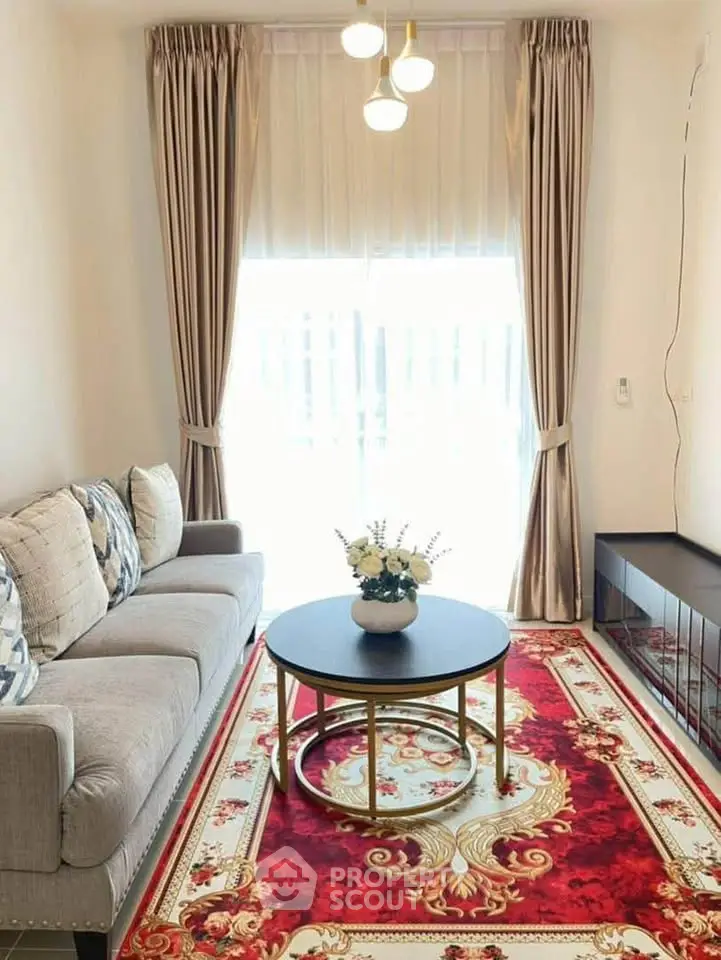 Elegant living room with plush sofa, ornate red carpet, and chic decor