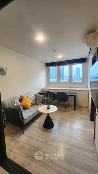 Chic modern living room with city view, cozy seating, and stylish decor.