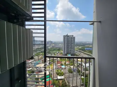 Stunning high-rise balcony view with cityscape and blue sky