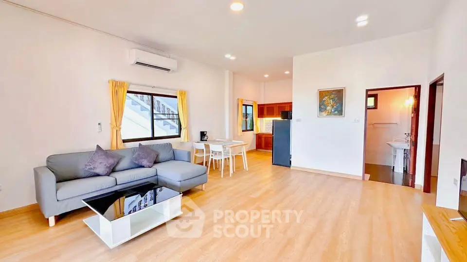 Spacious modern living room with open kitchen and stylish decor