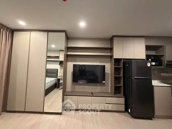 Modern apartment interior with sleek cabinetry and integrated appliances