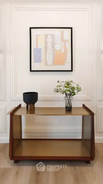 Elegant interior with modern console table and stylish wall art in a sophisticated living space.